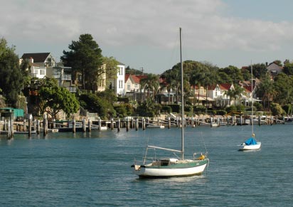 Shore of Sydney Harbour, with moorings and private jetties.